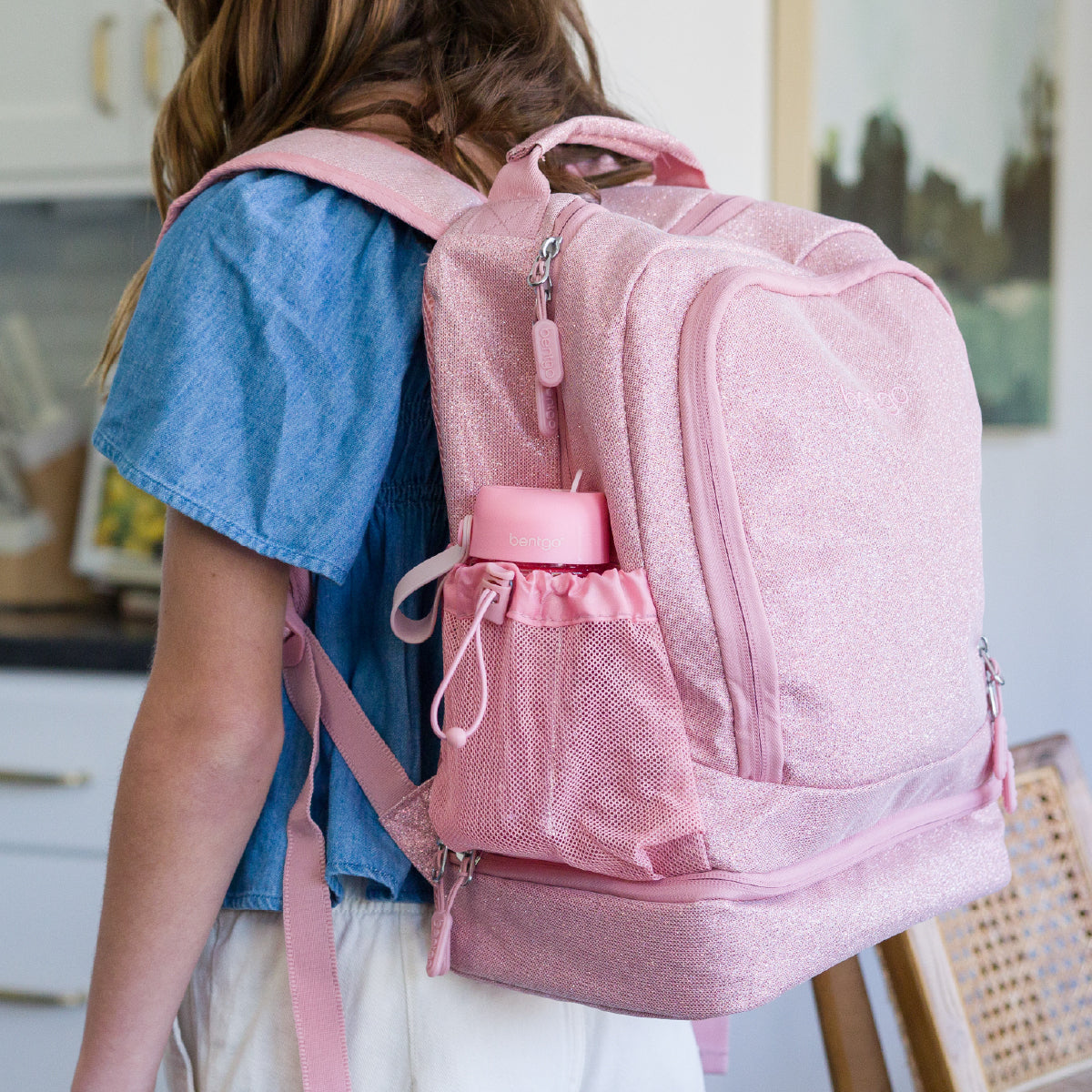 Person wearing a pink backpack indoors