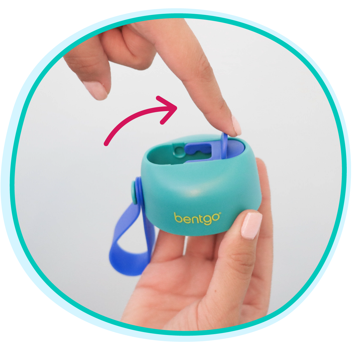 Hand holding a teal Bentgo container with a blue lid, showing how to open it.